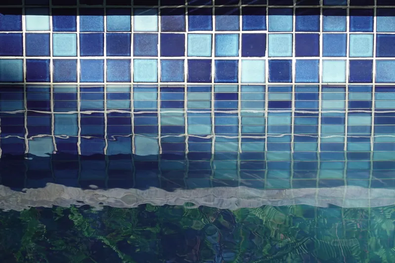 Example of blue glass mosaic waterline tile seen through rippling water